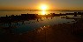 The still waters of the pool merge into the sunset across the Mar Menor